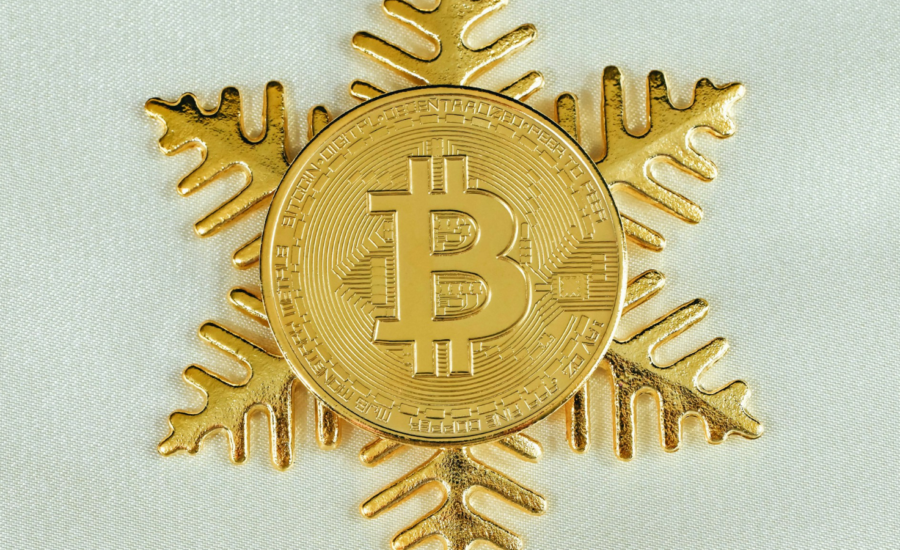 Gold coin shaped like a snowflake, stamped with a bitcoin logo