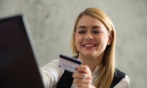 Canadian woman working at a payday loans, checking the risk of a potential client.