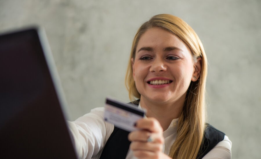 Canadian woman working at a payday loans, checking the risk of a potential client.