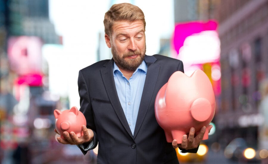 Canadian deciding between debt and investing holds two piggy banks.