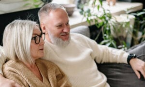 Canadian couple sitting together, wondering about moving money from RRSPs, RRIFs and TFSAs in retirement