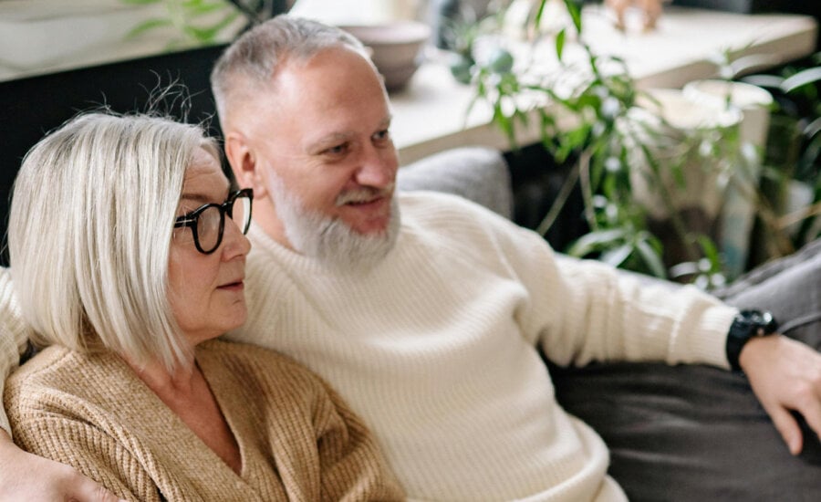 Canadian couple sitting together, wondering about moving money from RRSPs, RRIFs and TFSAs in retirement