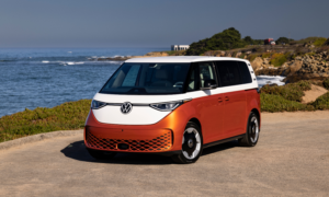 A Volkswagen ID Buzz mini van parked beside an ocean