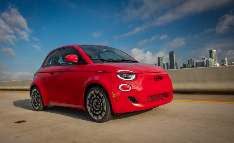 A Fiat 500e drives on a highway