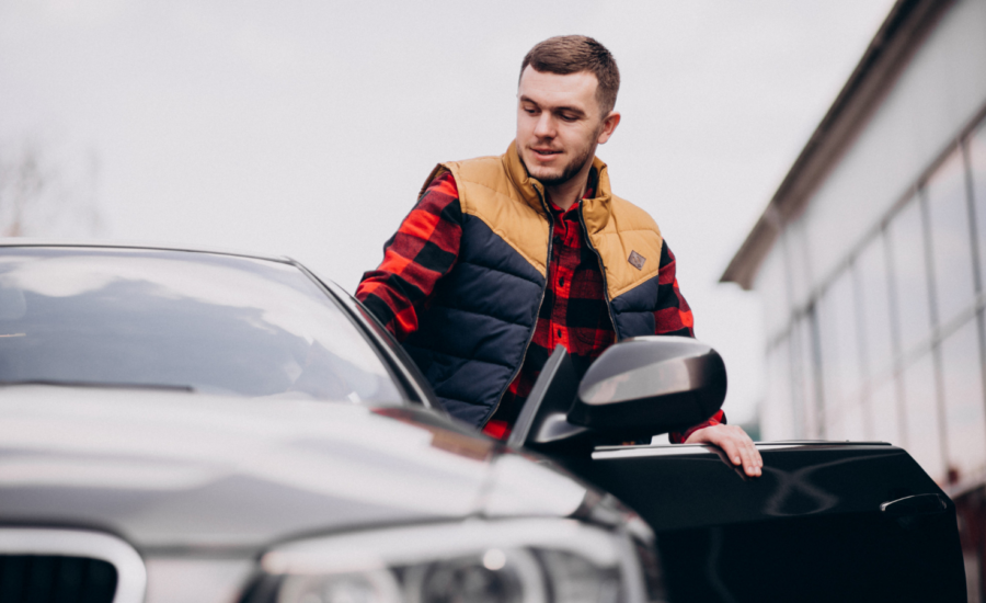 A young man gets behind the wheel of a car